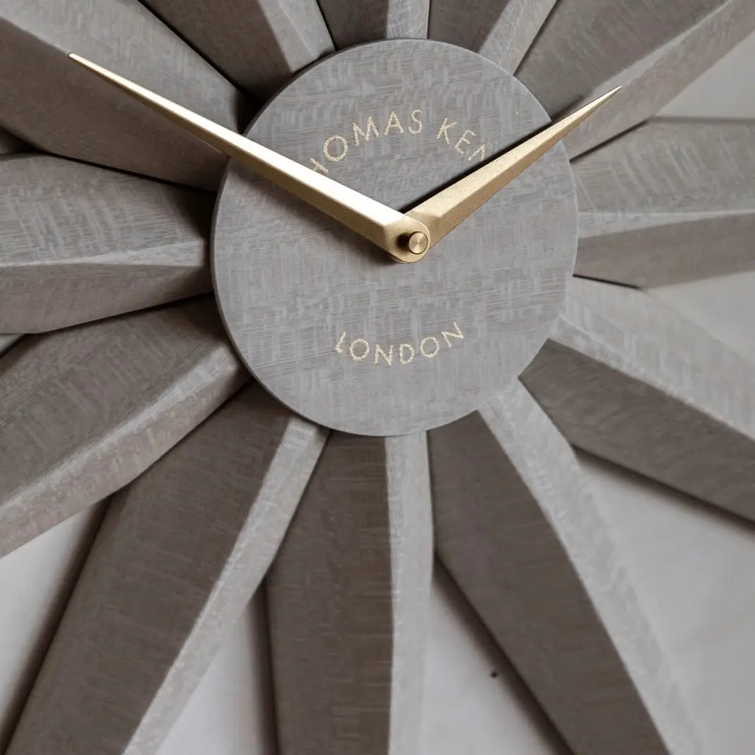 Starburst wooden statement wall clock crafted from wood shaped like the North Star. Accents of gold and matching gold clock hands, available to purchase at Albury House Interiors.