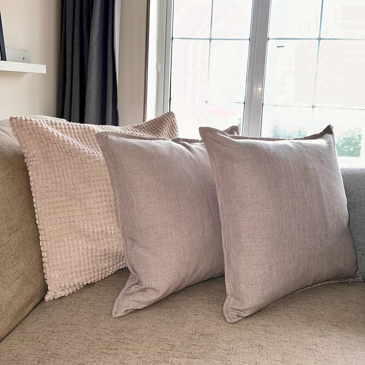taupe-natural-linen-square-piped-cushions-on-neutral-sofa-at-albury-house-interiors