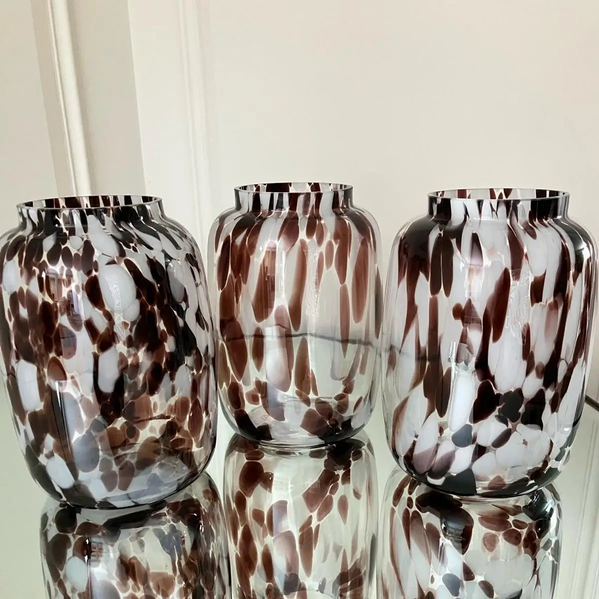 Hand blown brown and white glass oval curved shape vases with mottled, speckled patterns across the entire body, making each one completely unique. Shop these vases online or in store at Albury House Interiors. 