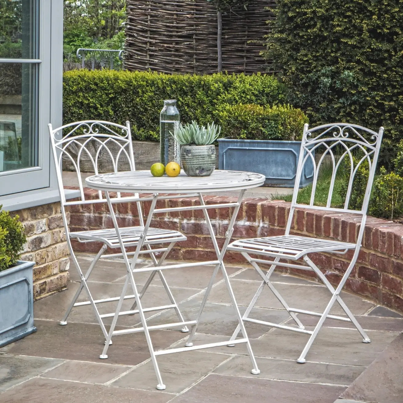 white metal garden table and chairs bistro set on a patio at Albury house interiors 