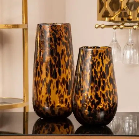 Tortoise shell slim amber glass vase with brown flecks and patterns throughout, in sizes small and large. Available to purchase at Albury House Interiors. 