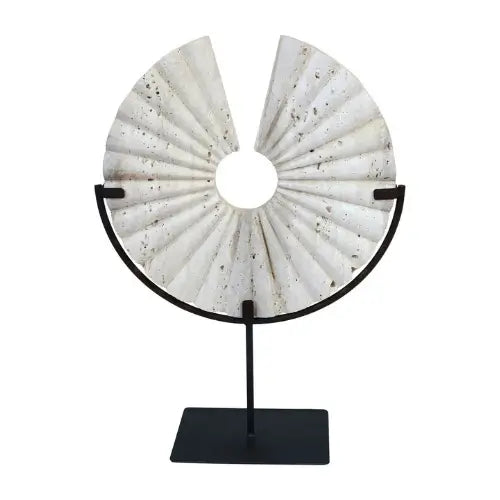 natural-travertine-stone-disc-sculpture-placed-on-matt-black-stand-at-albury-house-interiors