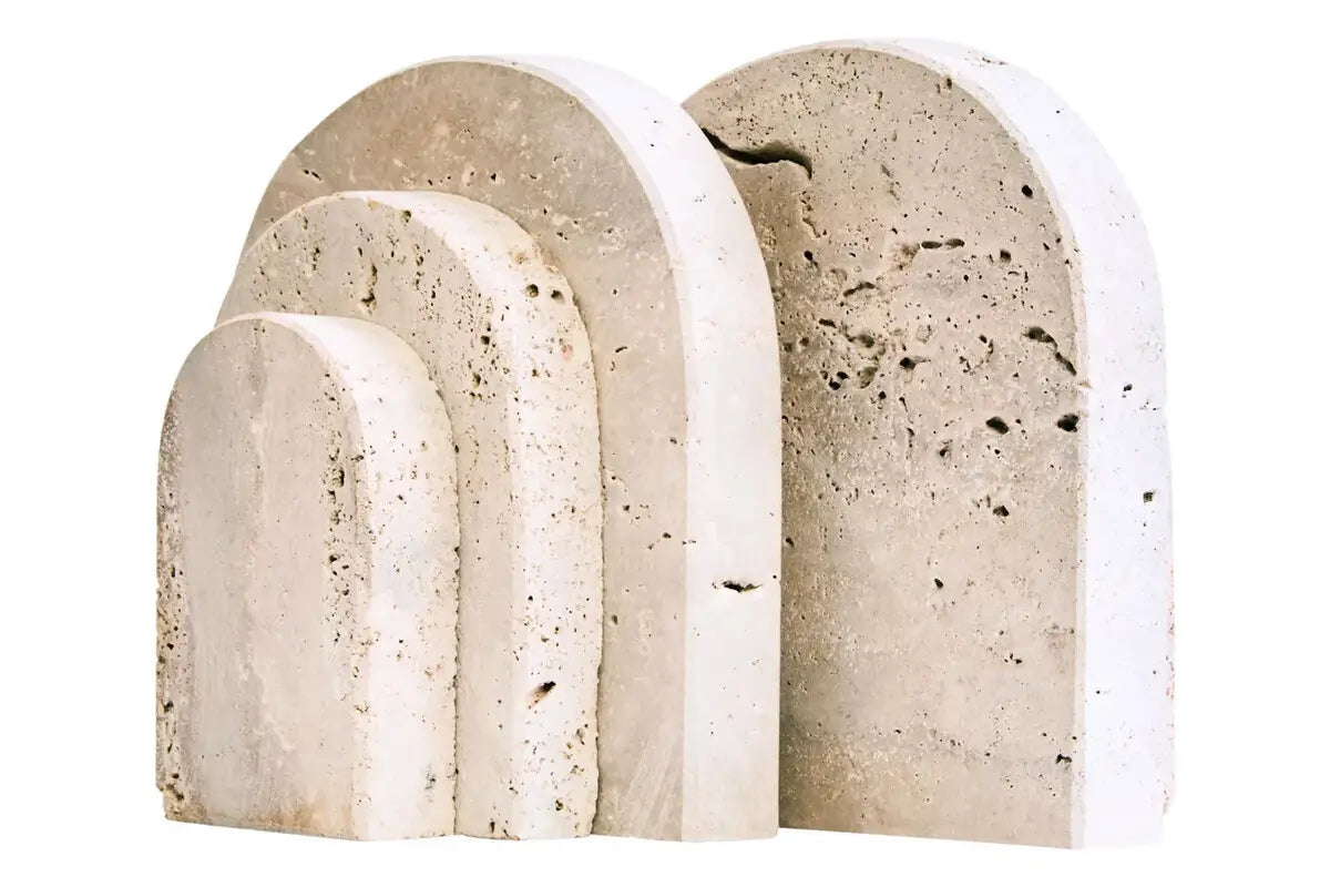 Natural travertine stone bookends, crafted in an arched shape with different sized steps. Perfect for styling your favourite books, available at Albury House Interiors.