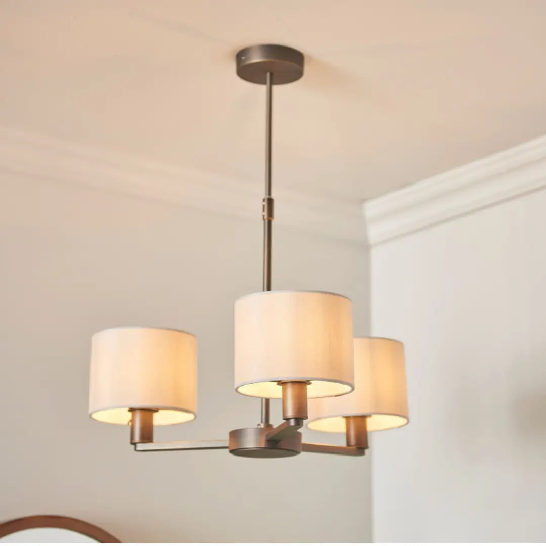 Trevi ceiling pendant with 3 arms finished in antique dark brushed bronze, and 3 faux silk shades. Whole collection available to purchase at Albury House Interiors.