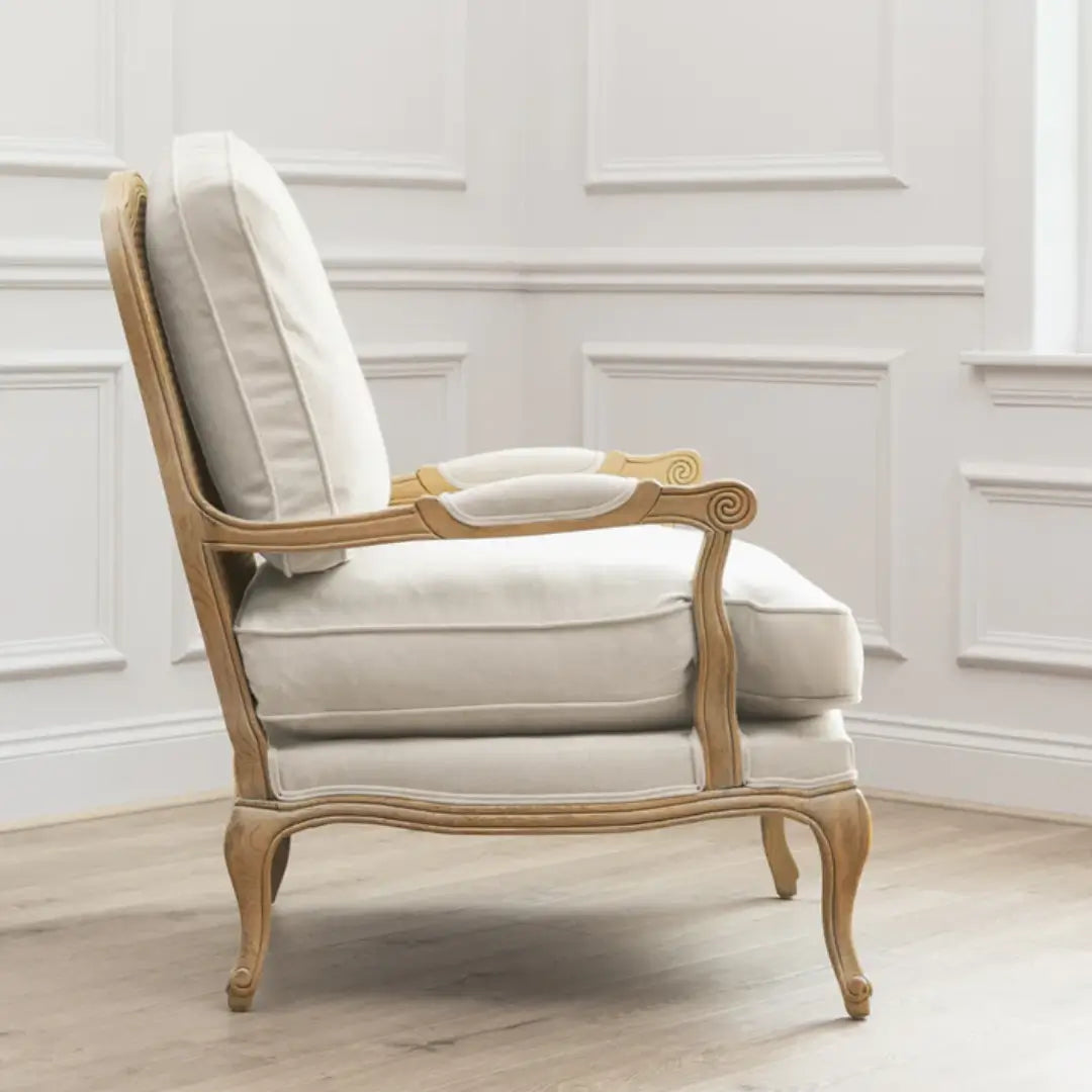 Valais arm chair crafted rom solid oak with rattan back. Cream linen upholstered seat and backrest cushion, with matching armrest padding. Available to purchase from Albury House Interiors in two colours.