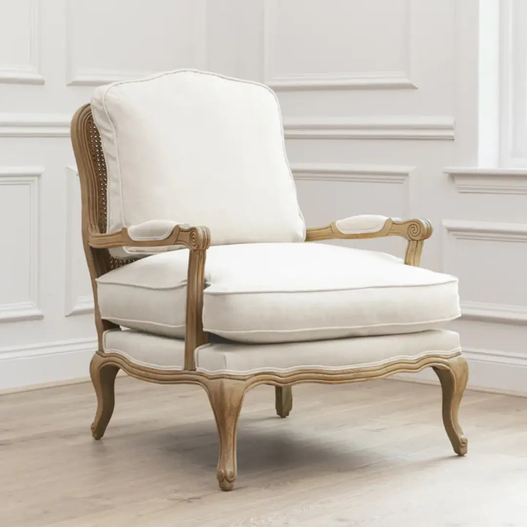 Valais arm chair crafted rom solid oak with rattan back. Cream linen upholstered seat and backrest cushion, with matching armrest padding. Available to purchase from Albury House Interiors in two colours.