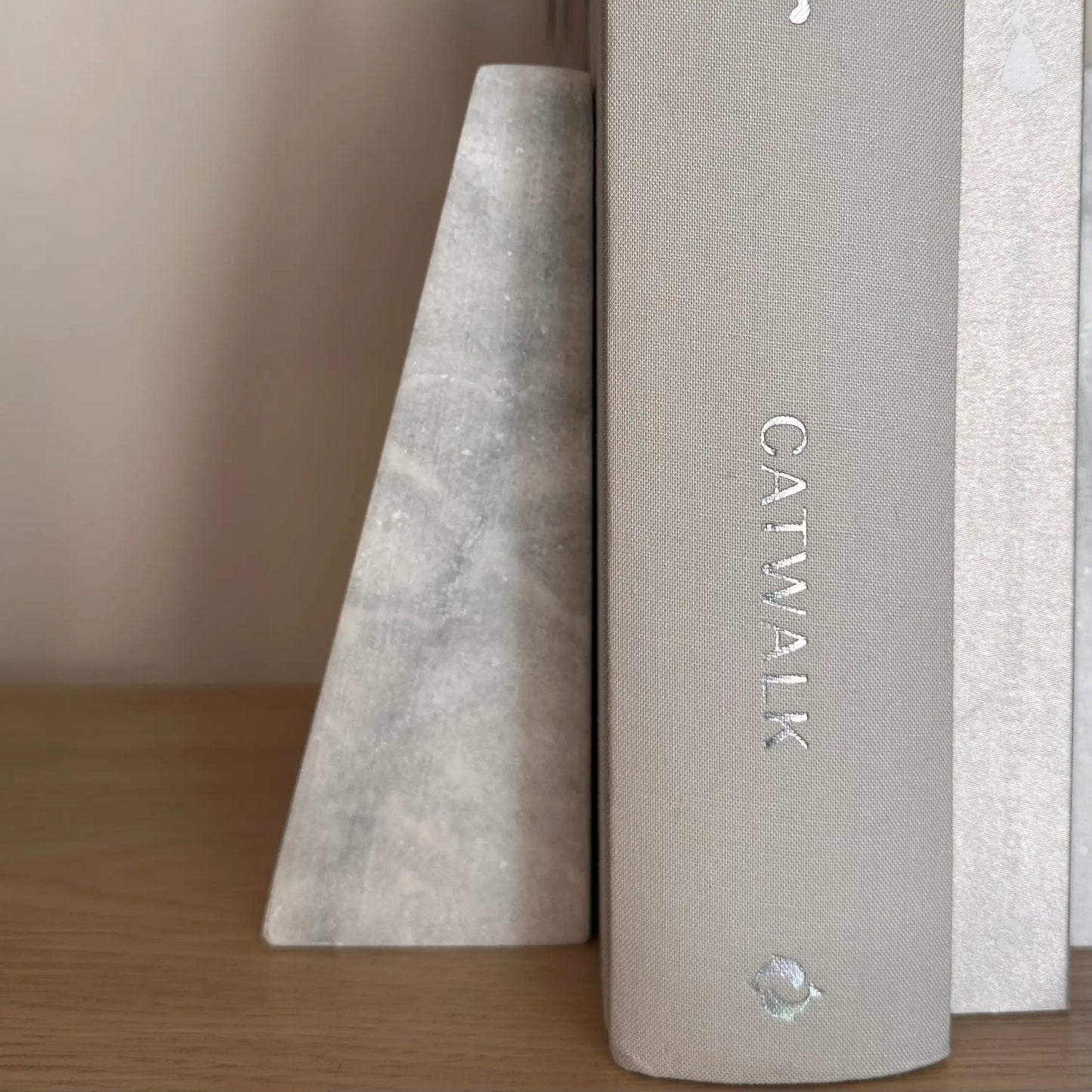 white-and-grey-veined-natural-marble-stone-bookends-with-grey-dior-designer-coffee-table-books-at-albury-house-interiors